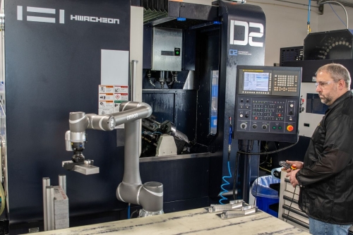 man operating an automated industrial machine